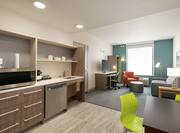 Spacious Accessible Suite Featuring Living Area With Kitchen, Sofa, And Work Desk