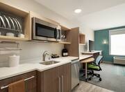 Spacious Accessible Suite Featuring A Fully Equipped Kitchen, Work Desk, And Lounge Area With TV