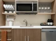 Convenient Fully Equipped Kitchen In Suite Featuring Dishwasher And Microwave