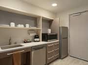 Bright Accessible Studio Suite Featuring Accessible Kitchen Fully Equipped With Refrigerator, Dishwasher, And Microwave