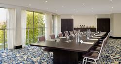 Windows With Long Sheer Drapes, Seating for 14 at Boardroom Table, Entries and Refreshment Station in Acron Room