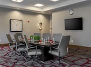 Wall Art, Entry, Wall Clock, TV, and Seating for 8 at Boardroom Table