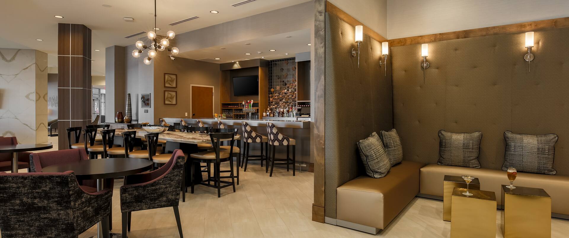 Soft Seating and Tables in Lounge Area With Counter Seating and TV at Fully Stocked Quarry Bar