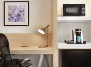 Work Desk, Microwave, and Coffee Machine in Double Queen Guest Room