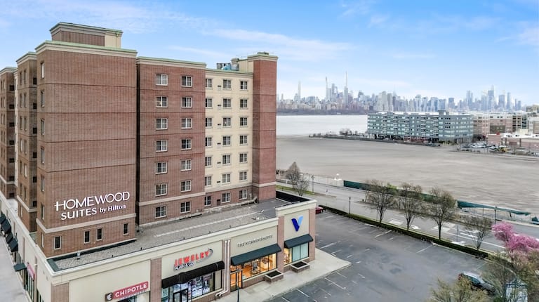 Hotel exterior with surrounding car park and water