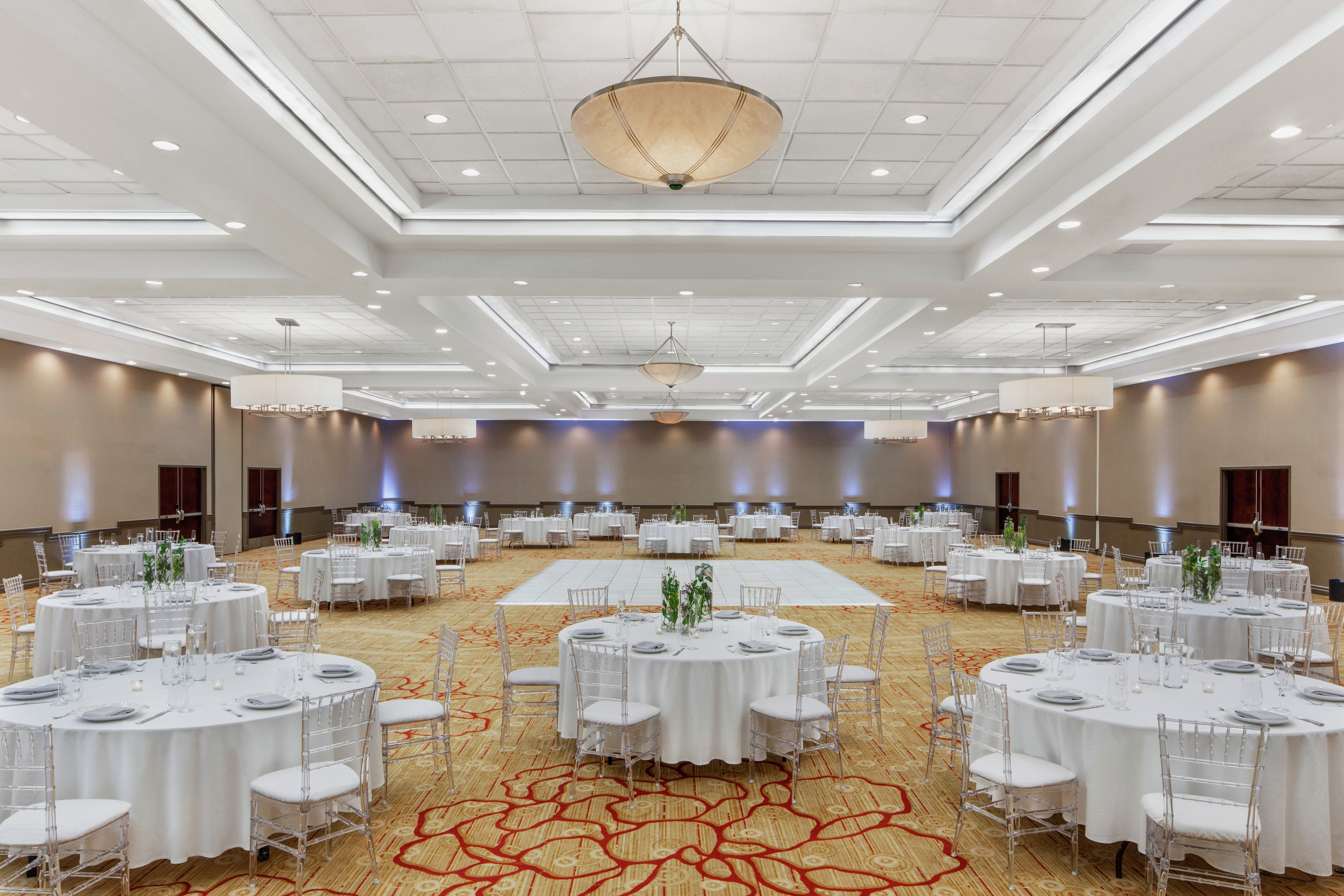 round banquet tables in a ballroom with a dance floor