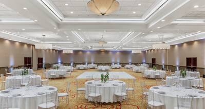 round banquet tables in a ballroom with a dance floor
