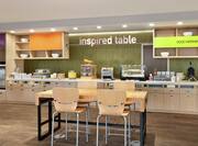 Bright breakfast area featuring complimentary buffet fully stocked with delicious food and beverages.