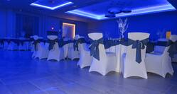 Hotel Ballroom Decorated with Chairs and Tables, and Blue Lighting for an Event