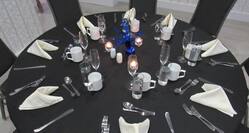 Decorated Banquet Table with Candles and Silverware