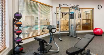 Fitness Center Area with View of Indoor Pool