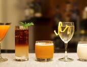 Five creative cocktails sitting on bar