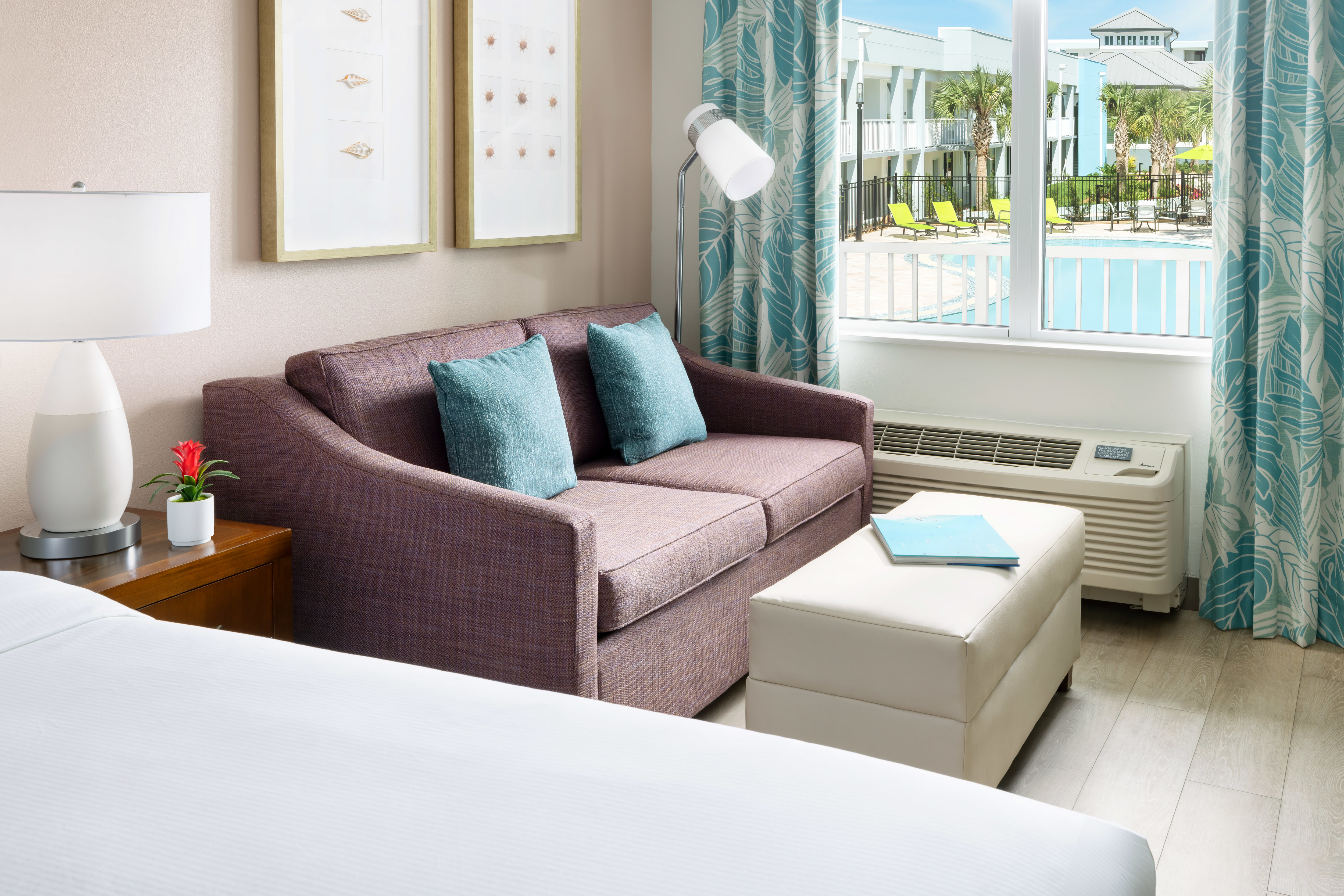 Bed, Sofa in a Guest Room with Pool View