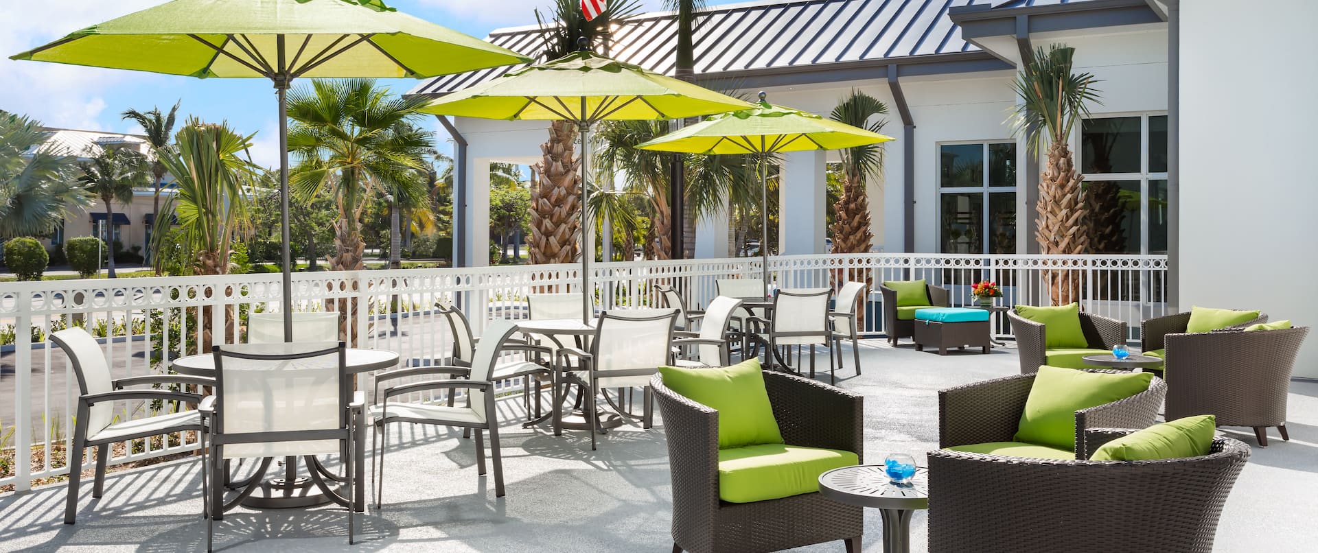 Outdoor seating area with tables, chairs and parasols