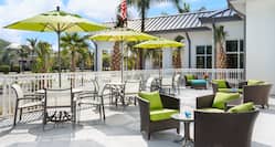 Outdoor seating area with tables, chairs and parasols