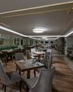 Tables, Chairs, Booths, and Windows With Night View in Restaurant Dining Room Area