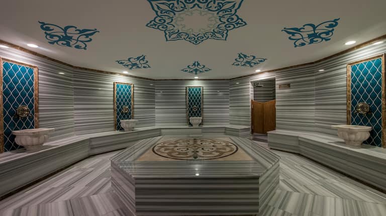 Overview of Turkish Bath  Interior With Ceiling Mural, Seating and Hand Basins