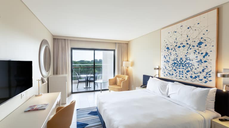 King Guest Room with HDTV, Desk, Armchair and Balcony with Sitting Area