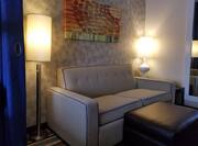 Sofa sleeper with two lamps, footrest, wall art