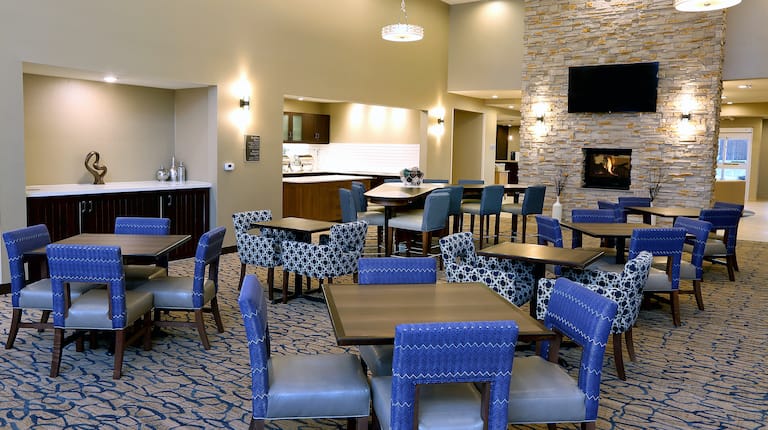 Lobby Seating Area with Chairs, Tables, Fireplace and Wall Mounted HDTV