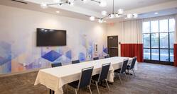 Large Table in Meeting Room with HDTV
