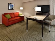 Accessible Guest Room Lounge Area with Sofa, Television and Work Desk