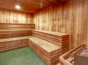 Wooden Sauna Interior With Heater in Corner