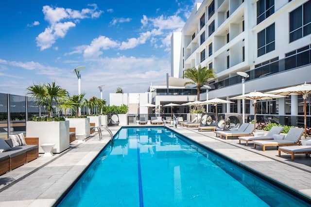 Outdoor Pool with Seating Area and Palm Trees