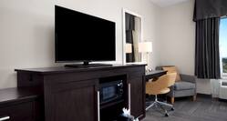 HDTV Microwave Coffemaker Work Desk and Armchair in Hotel Guest Room 