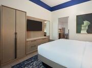 King suite bedroom with wall mounted TV