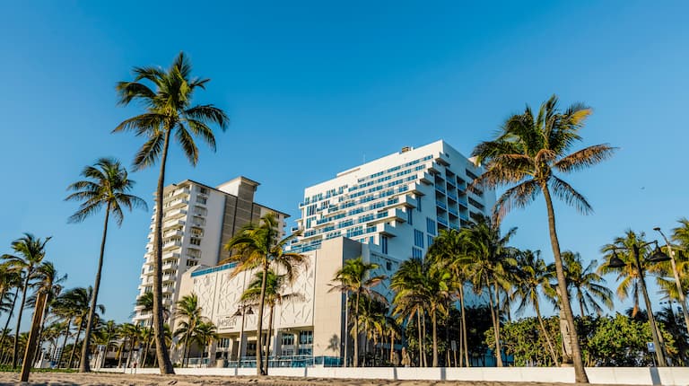 Hotel exterior with beach and palm trees