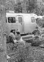 Family sitting outside an airstream