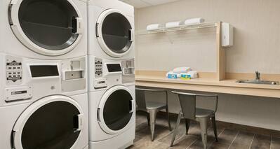 Laundry area with machines and waiting area