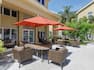 Spacious outdoor patio for guests to enjoy featuring ample seating, dining tables, and bbq grills.