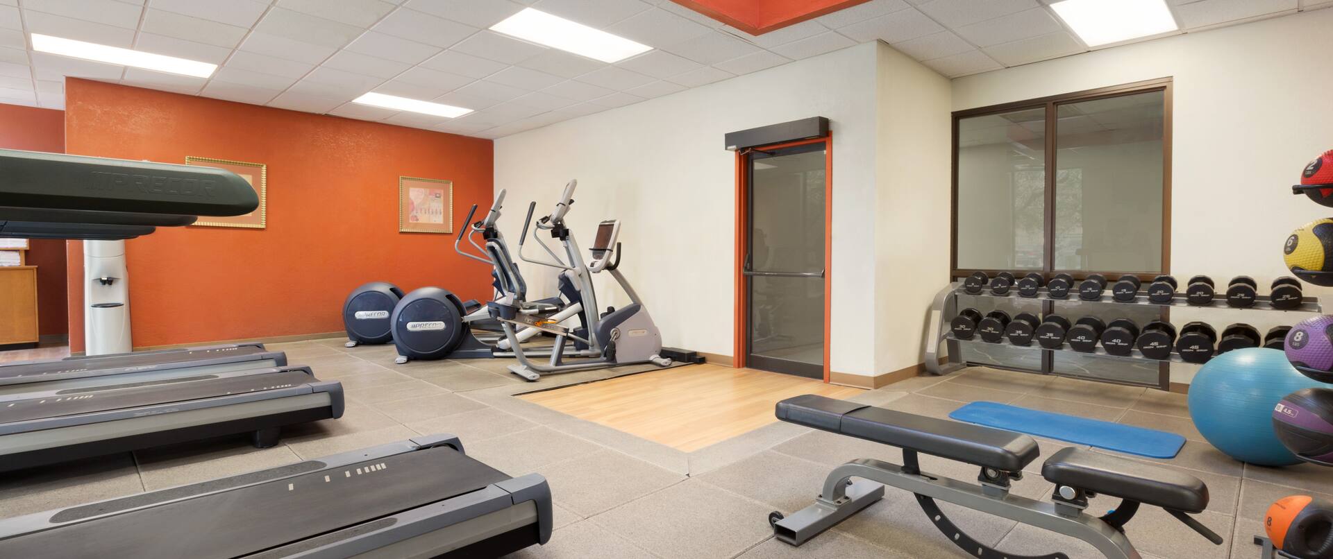 Fitness center with cardio machines and bench