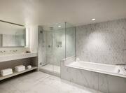 Guest Bathroom with Large Mirror, Sink, Walk-In Shower and Bath Tub