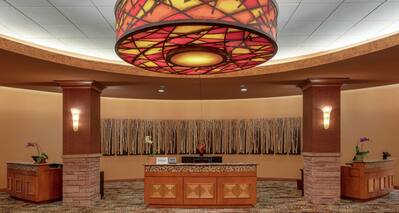 View of Front Desk, Wall Art, and Circular Ceiling Light Fixture