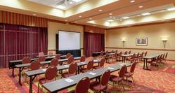 Tables and Chairs in Classroom Style Setup with Projector Screen in Lake Loveland A and B Meeting Rooms