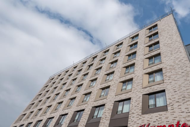 Daytime View of Hotel Exterior With Signage