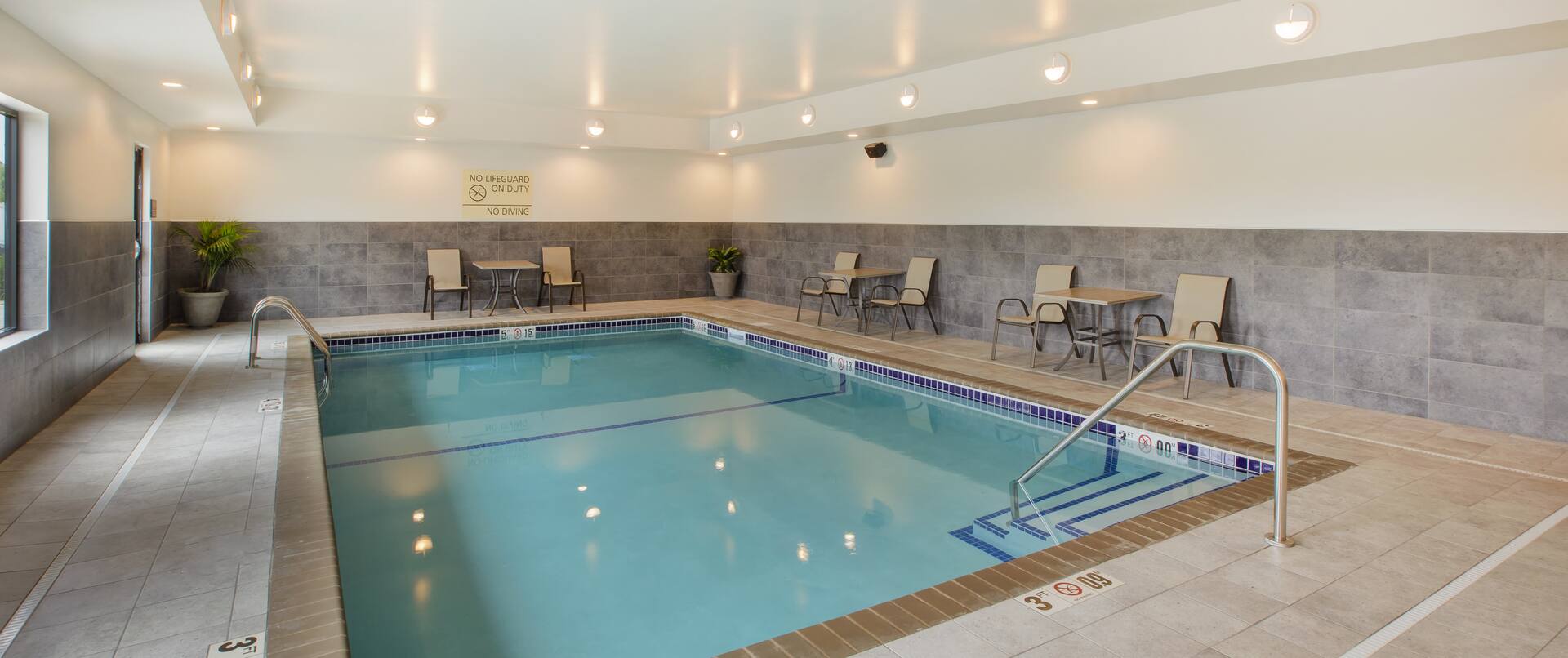 Indoor Pool with Tables and Chairs