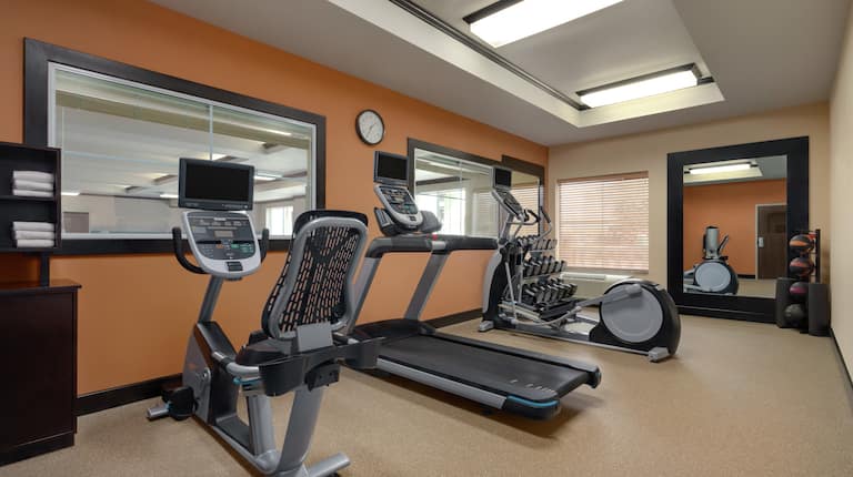 Spacious on-site fitness center fully equipped with cardio machines, free weights, and medicine balls.