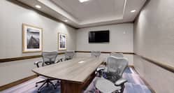 Meeting Room with Table, office Chairs and Wall Mounted HDTV