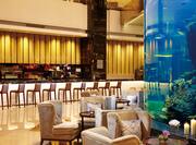 Hilton Foshan Hotel, China - Bar with Barstools and Lounge Seating next to Aquarium