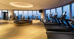 Modern Fitness Center with Large Windows Offering City View