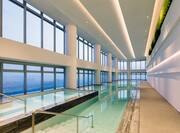 Indoor Pool Area with Large Windows Offering City View