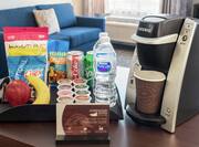 Complimentary premium suite offerings featuring coffee, bottled water, soda, and other delicious snacks for guests to enjoy.