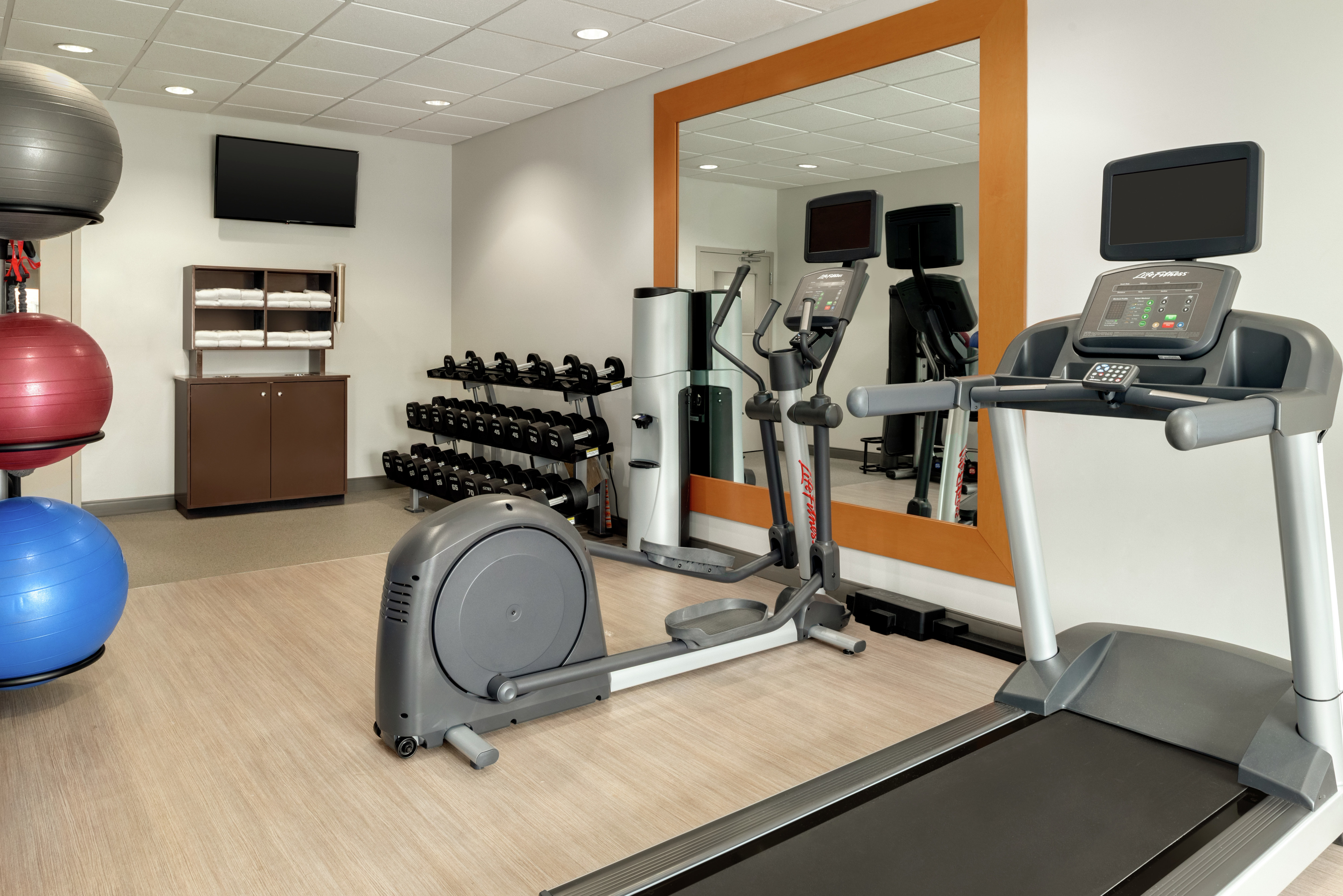 Convenient on-site fitness center fully equipped with cardio machines, free weights, and TV.