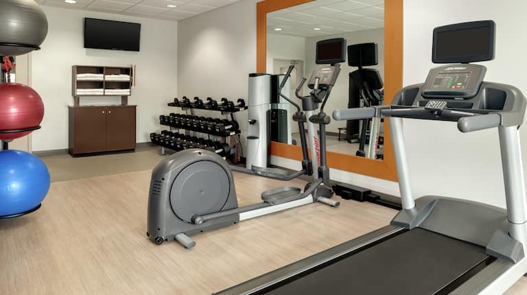 Convenient on-site fitness center fully equipped with cardio machines, free weights, and TV.