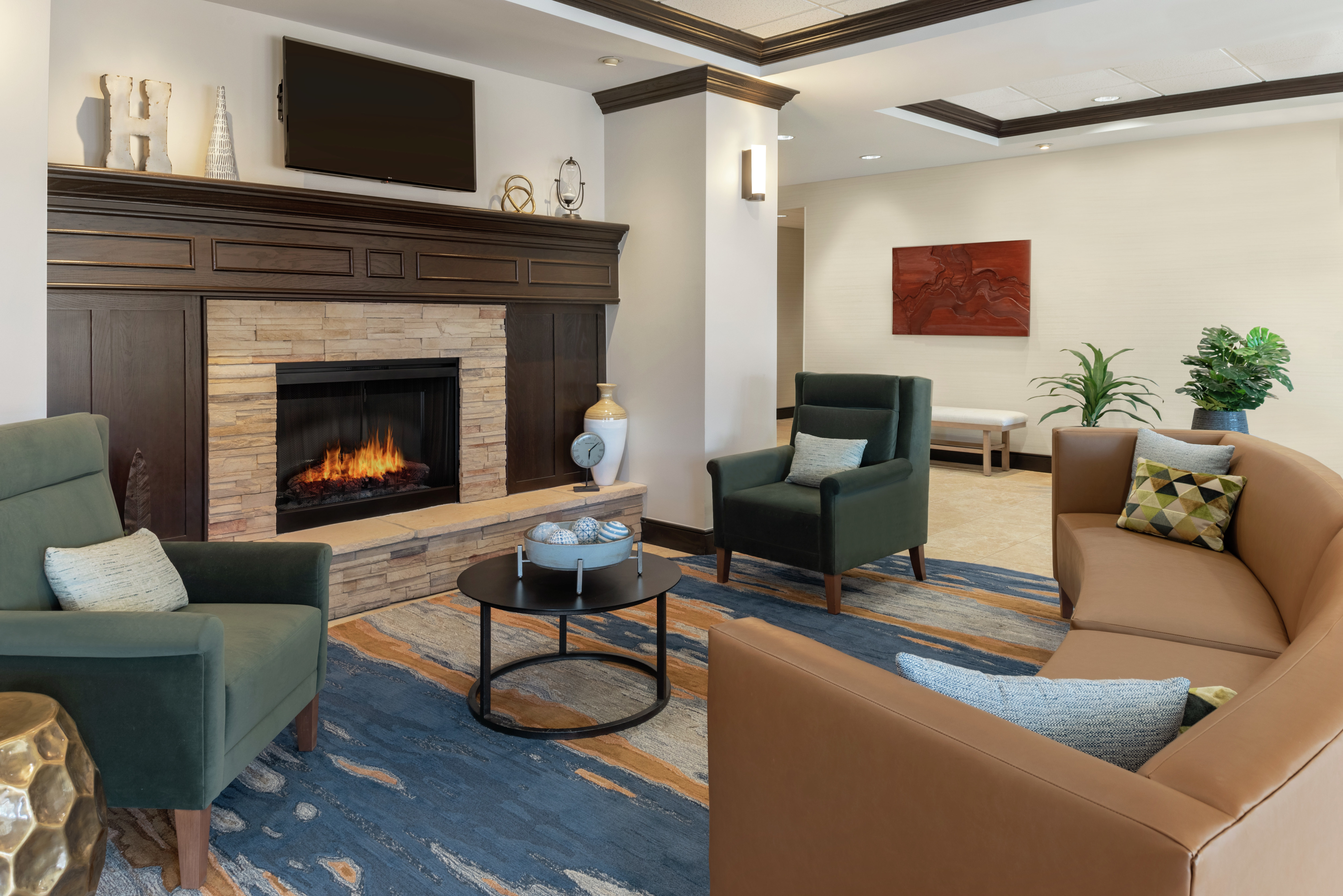 Stylish lodge area for guests to relax featuring beautiful fireplace and comfortable seating.