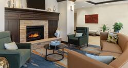 Stylish lodge area for guests to relax featuring beautiful fireplace and comfortable seating.
